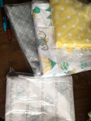 Three flannel prints for the top of the quilt. The lower fabric is a simple quilt cotton for the crib sheet. Adorable, yes?